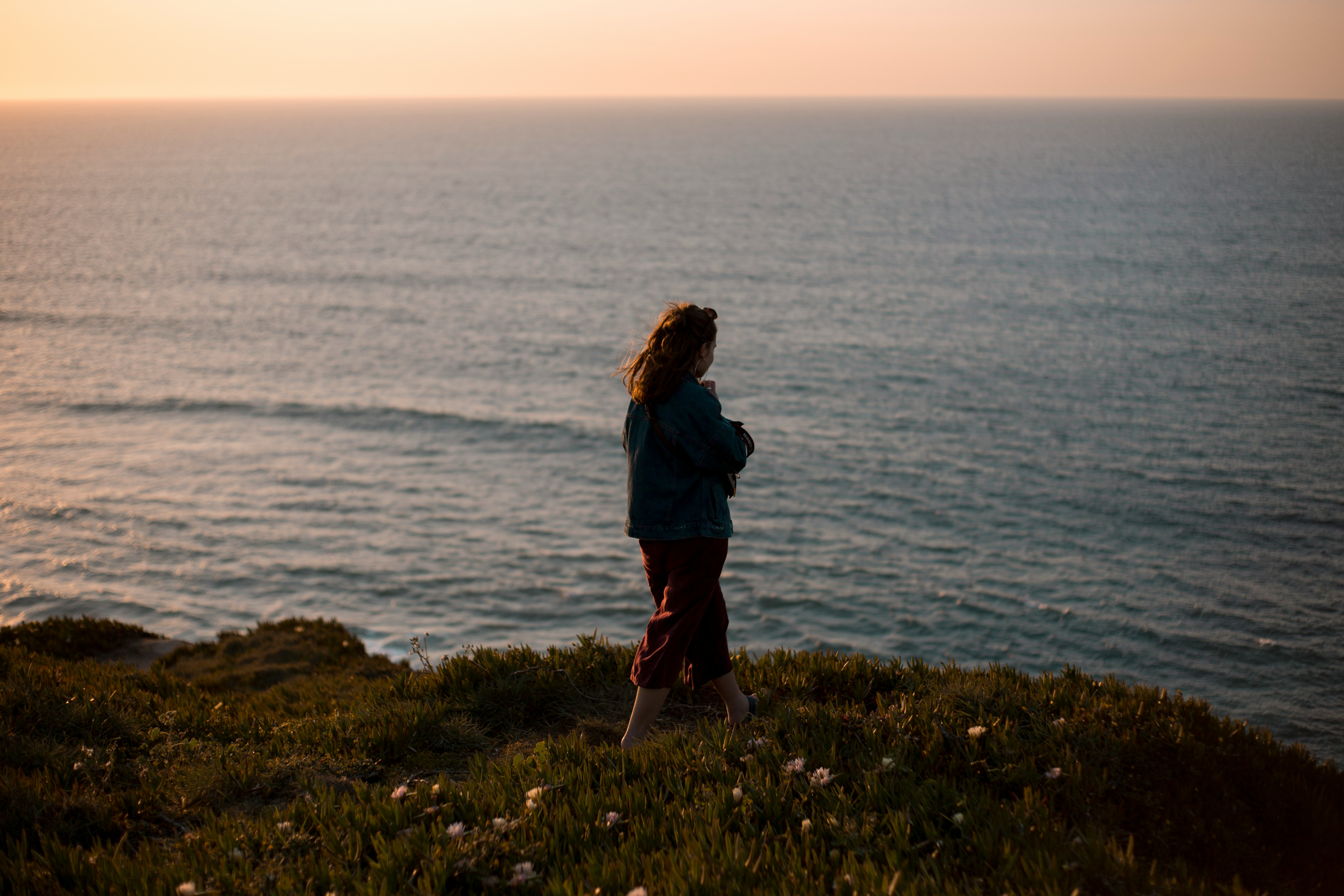 woman standing near edge of mountain